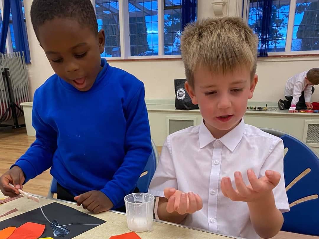 Children gluing coloured paper